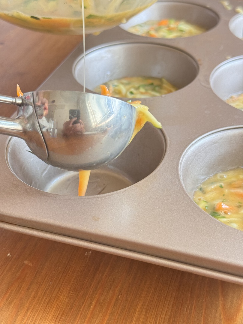 Pour the egg and vegetable mixture into the muffin cups