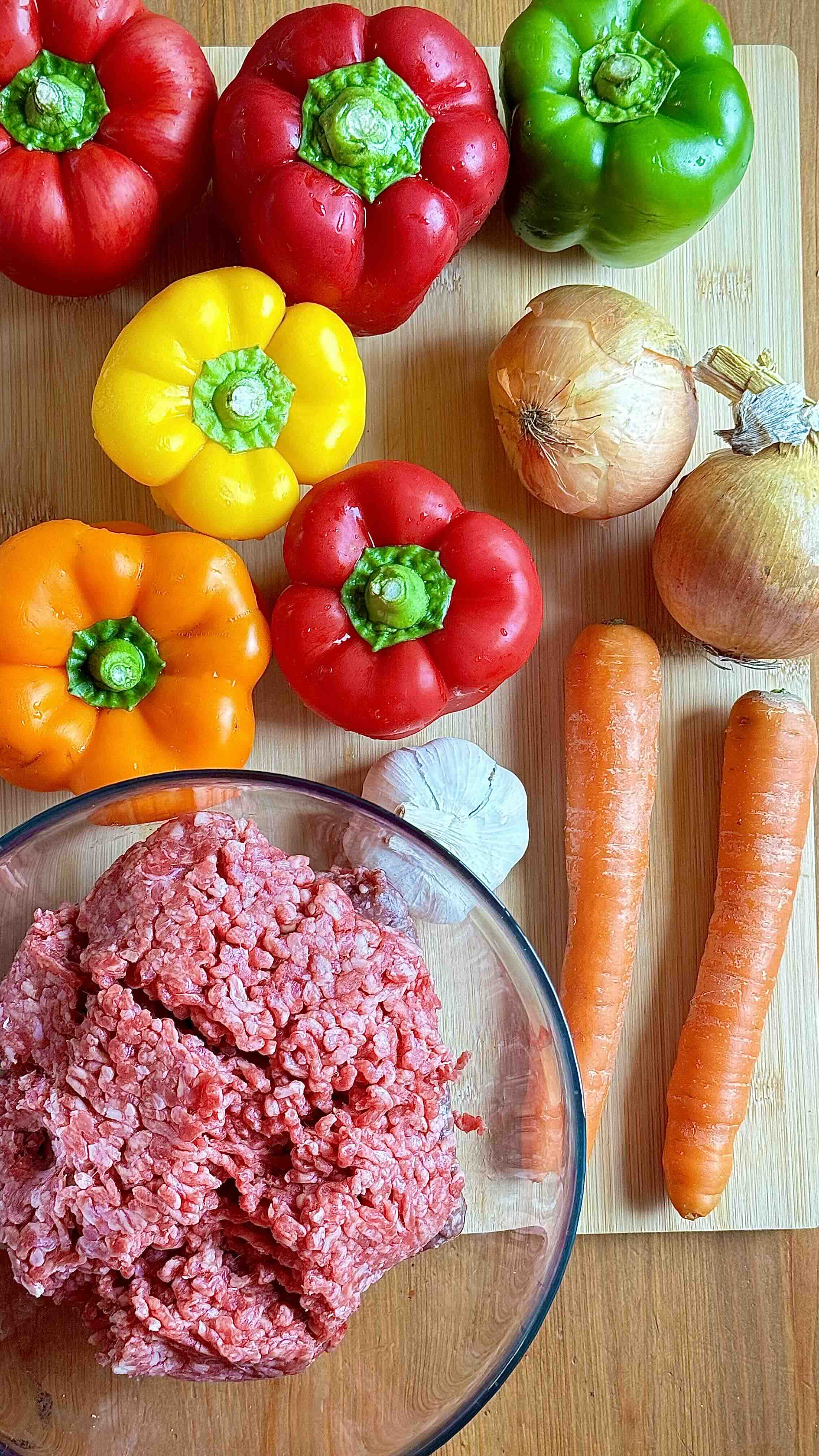 Ingredients for Stuffed Bell Peppers with Meat and Rice in Creamy Tomato Sauce