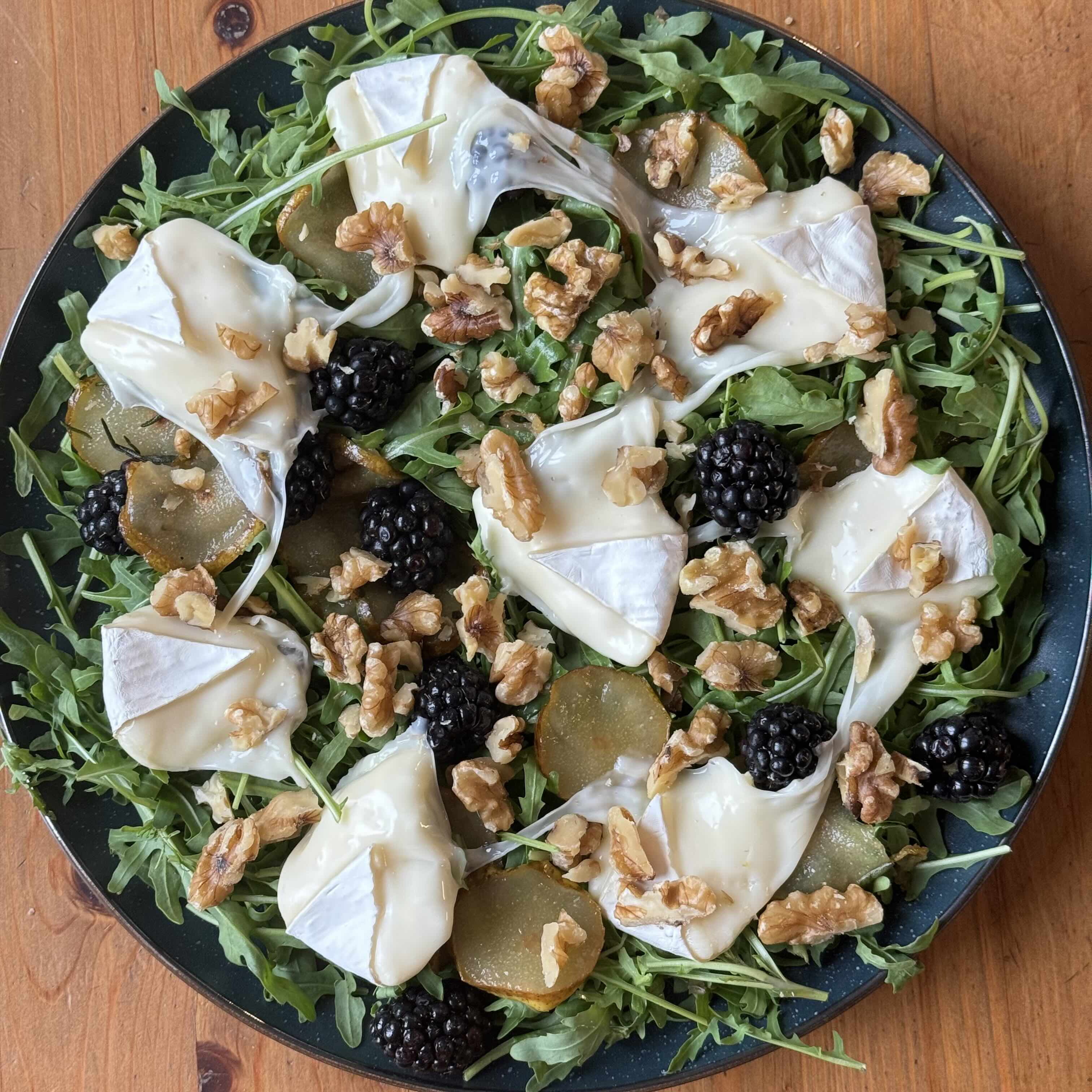 Warm Arugula Salad with Caramelized Pear, Melted Camembert, and Blackberries