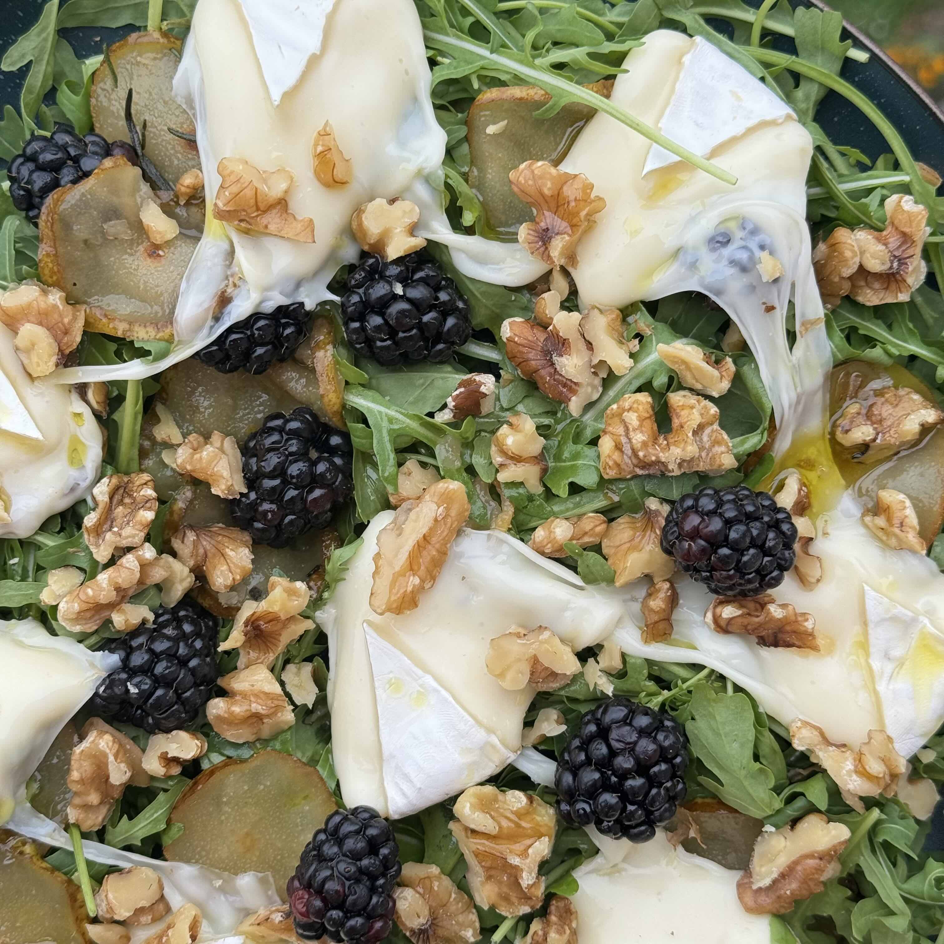 Warm Arugula Salad with Caramelized Pear, Melted Camembert, and Blackberries