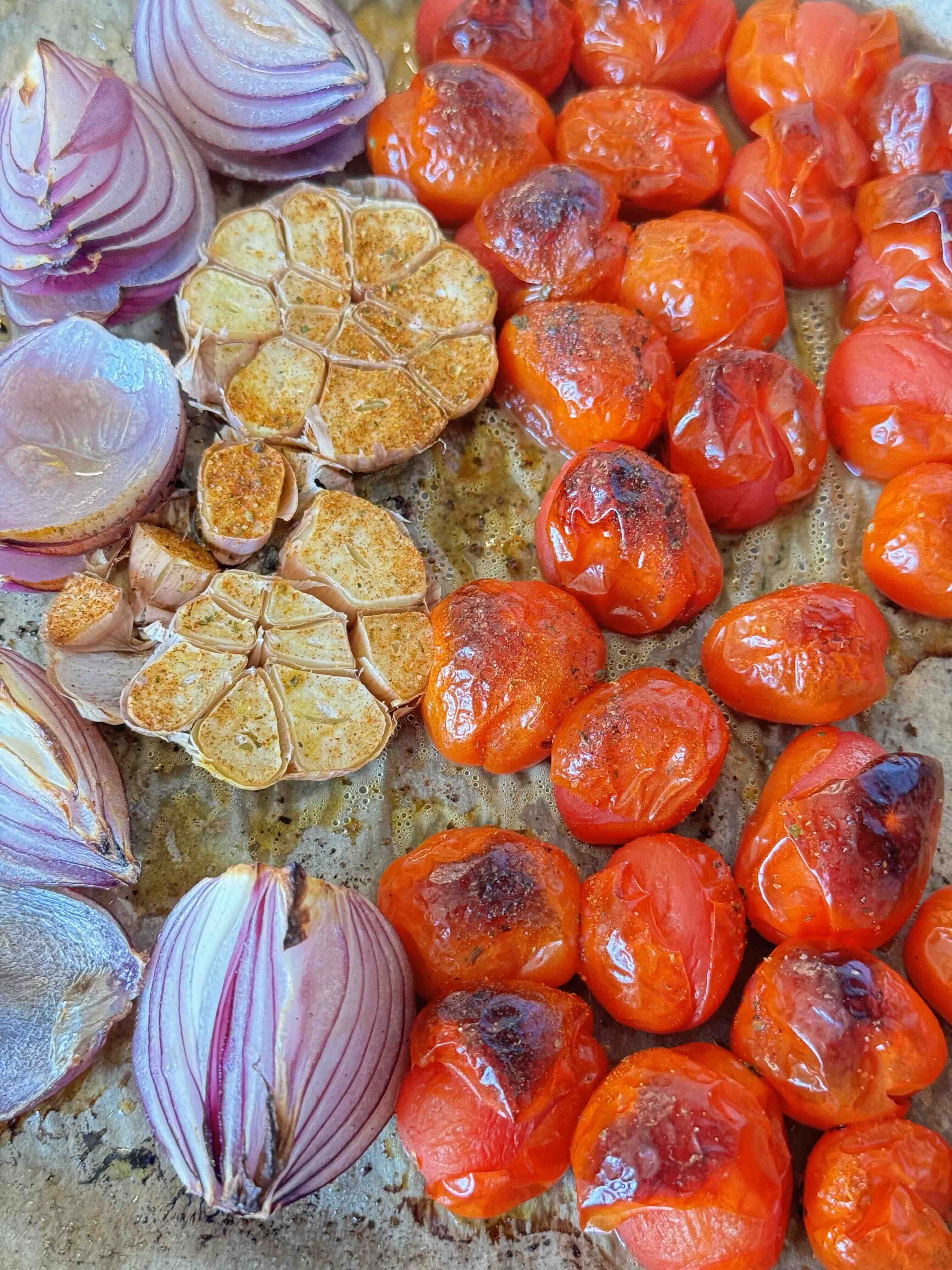 Roast the Vegetables Tomatoes, red onion and garlic in oven