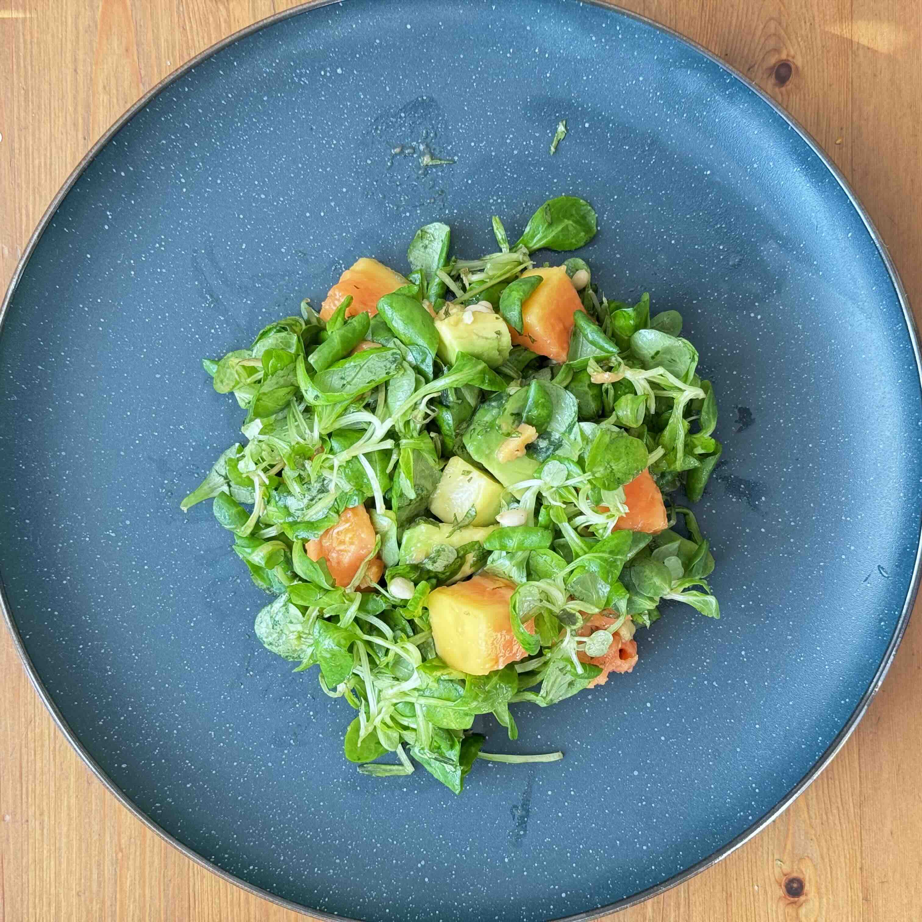 Papaya and Mung Bean Salad with Avocado and Pine Nuts on a plate