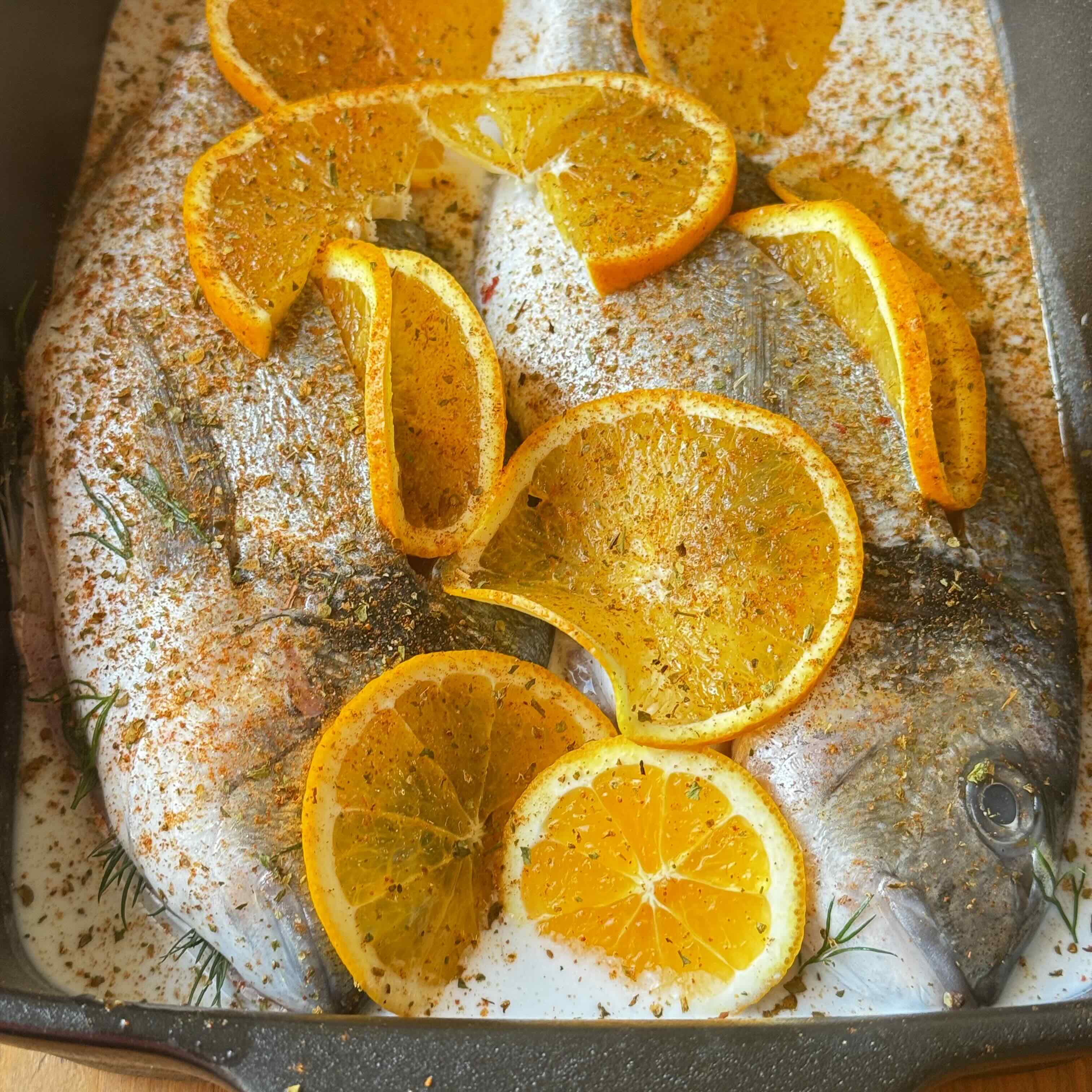 Dorado with coconut cream and orange ready to be baked 