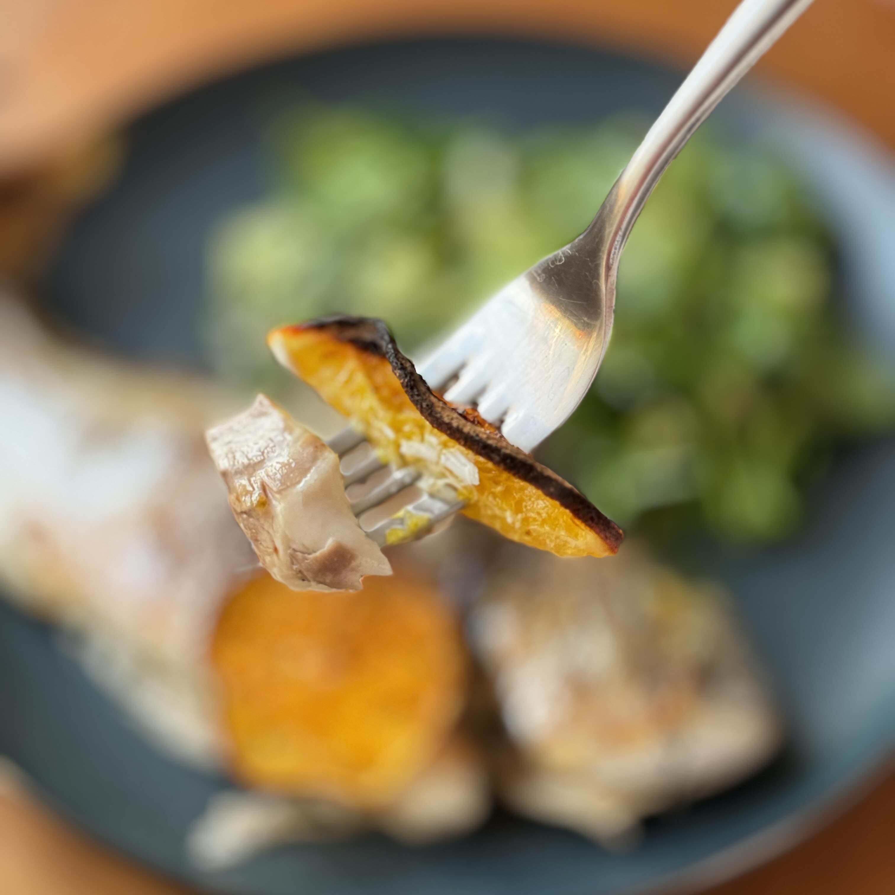 Baked dorado with coconut cream and fresh orange ready to eat