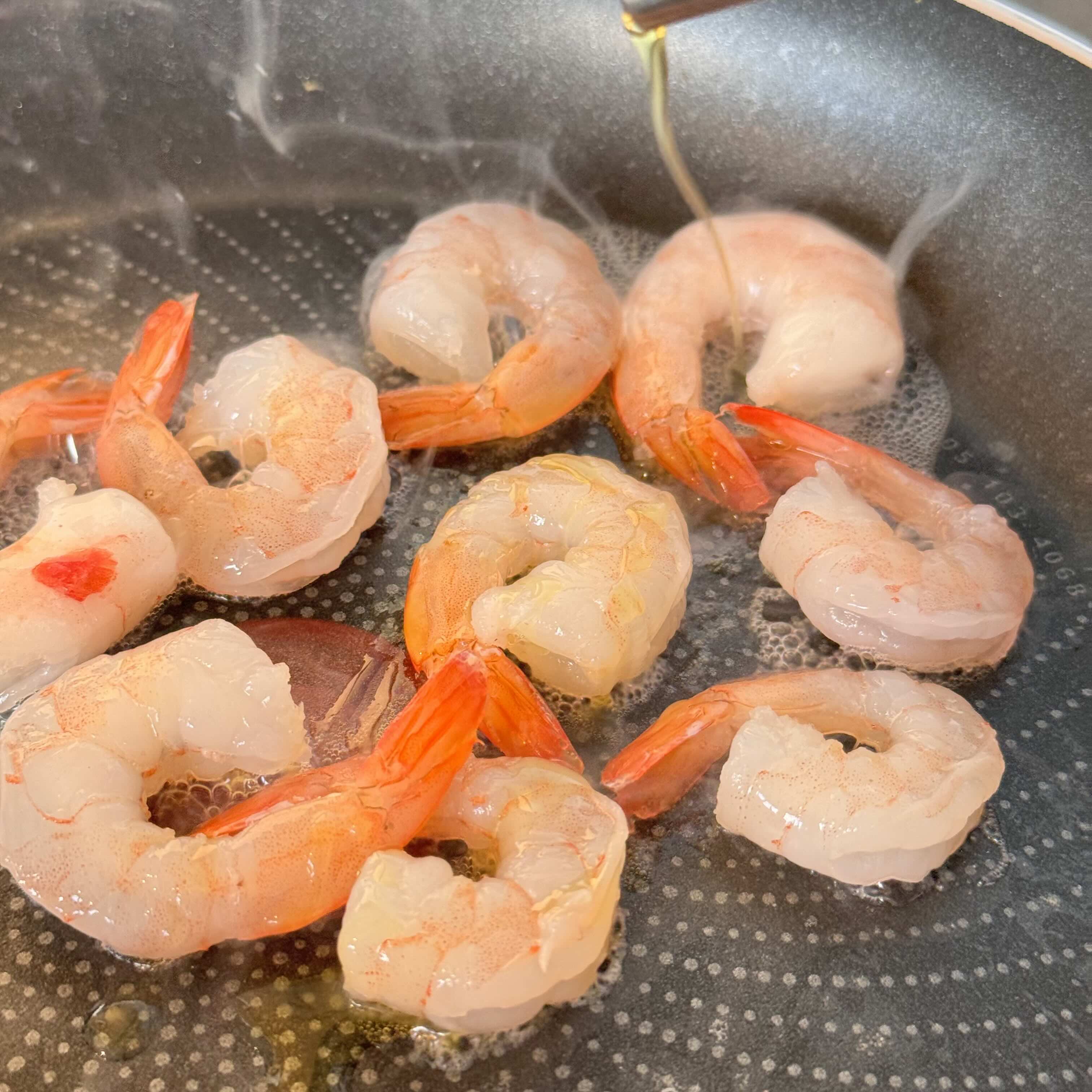 shrimp for spring rolls in a frying pan