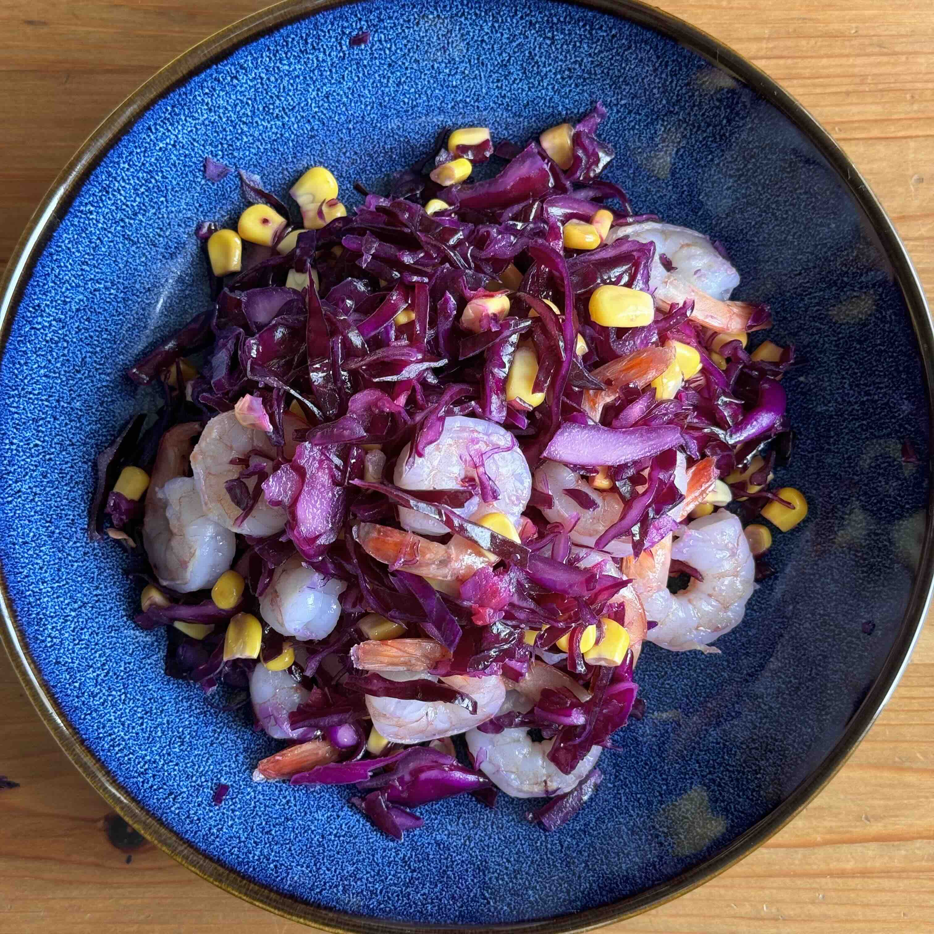 Red Cabbage shrimp salad with lemon and corn on a plate