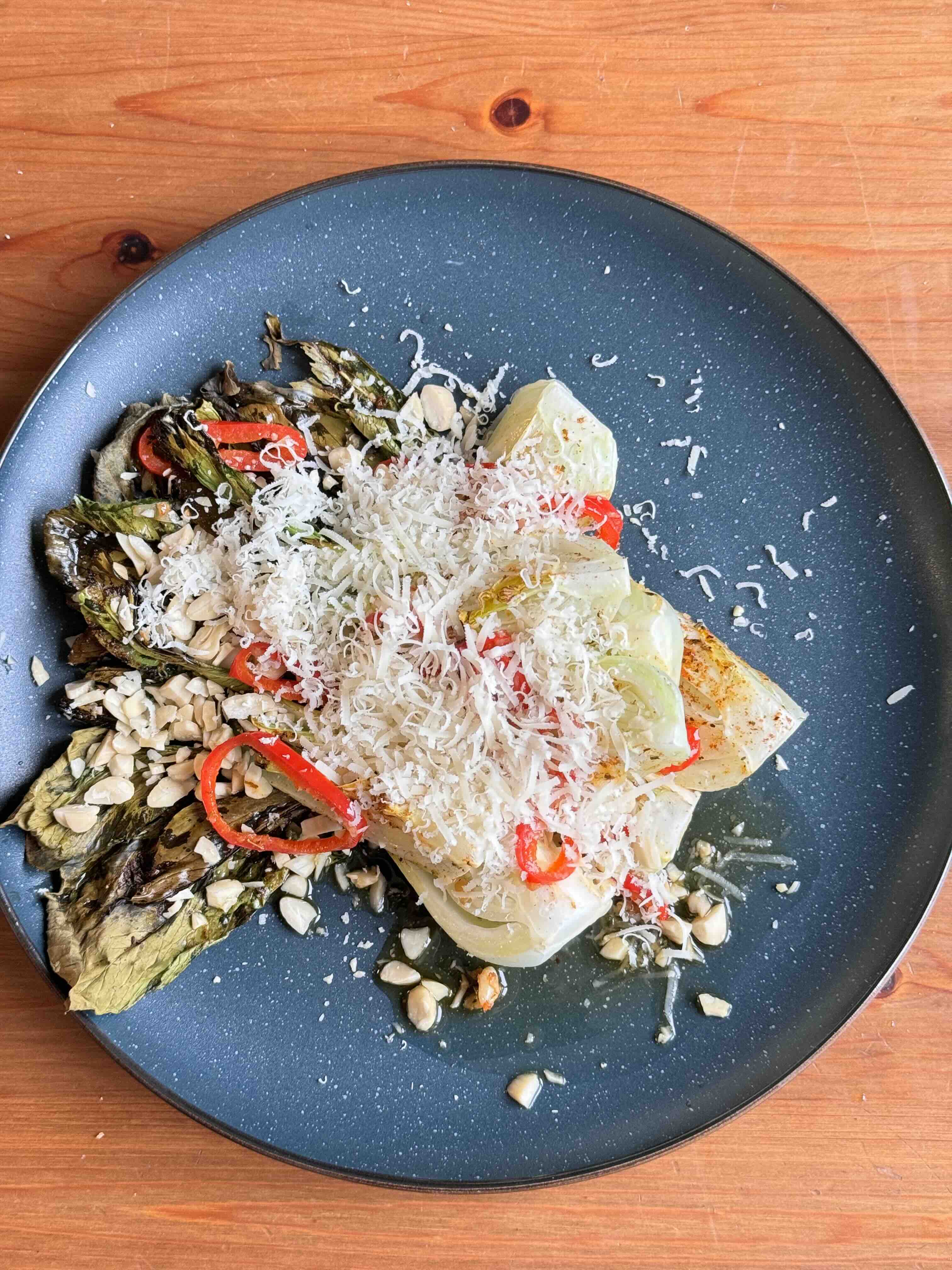 Roasted Pak Choi with Lemon Butter Sauce, Almonds, and Parmesan on a plate