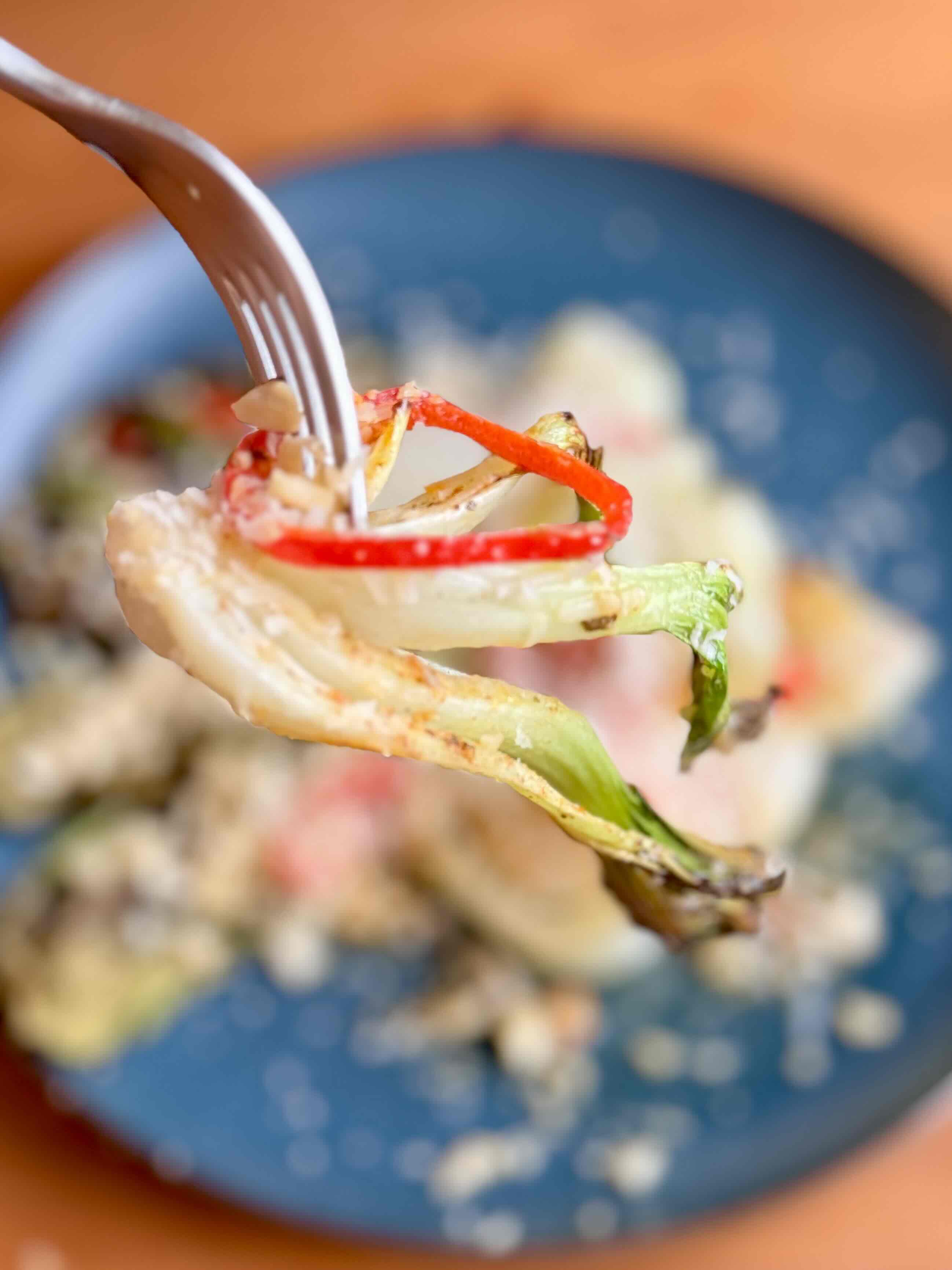 Roasted Pak Choi with Lemon Butter Sauce, Almonds, and Parmesan on a fork