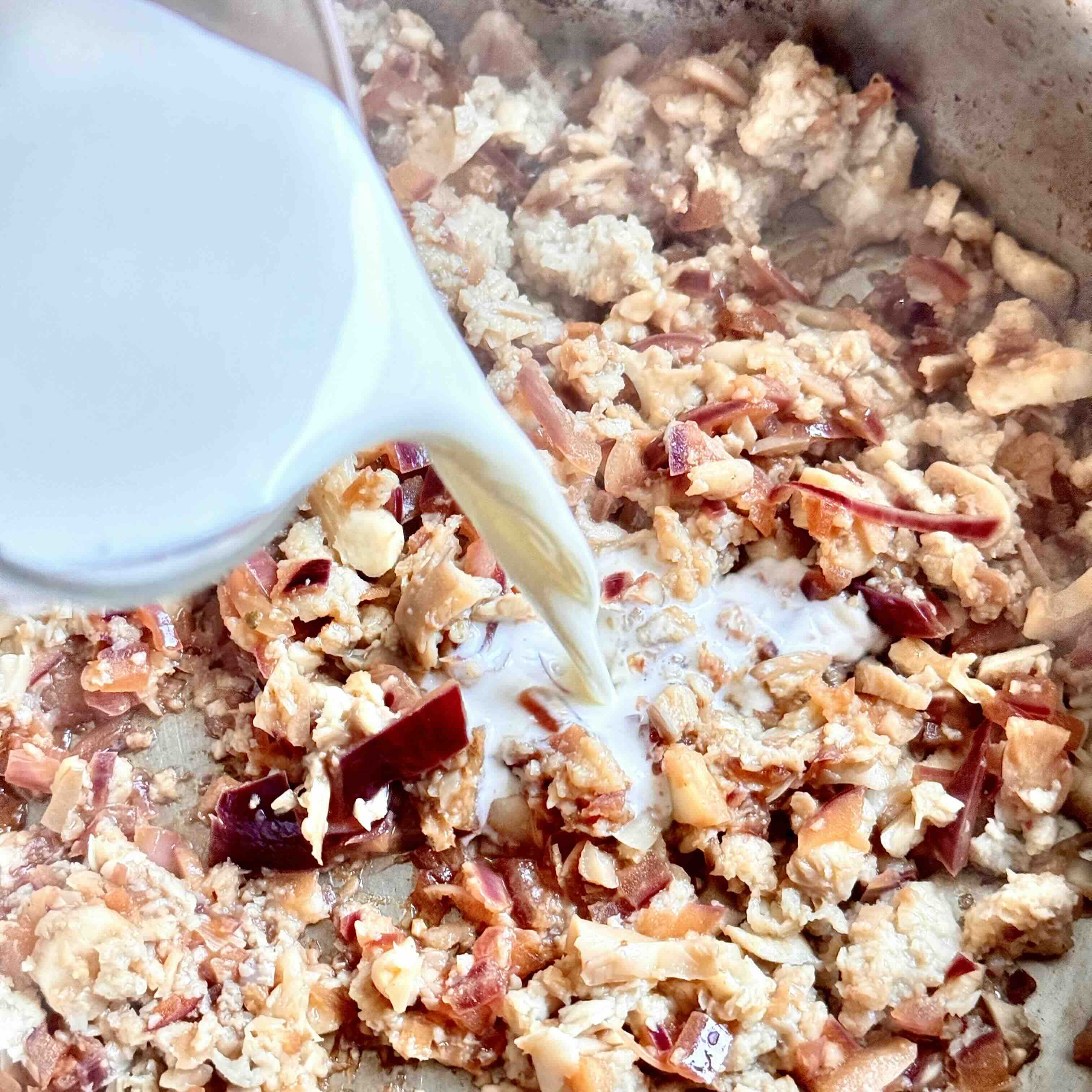 Rich cream sauce bubbling in a skillet.