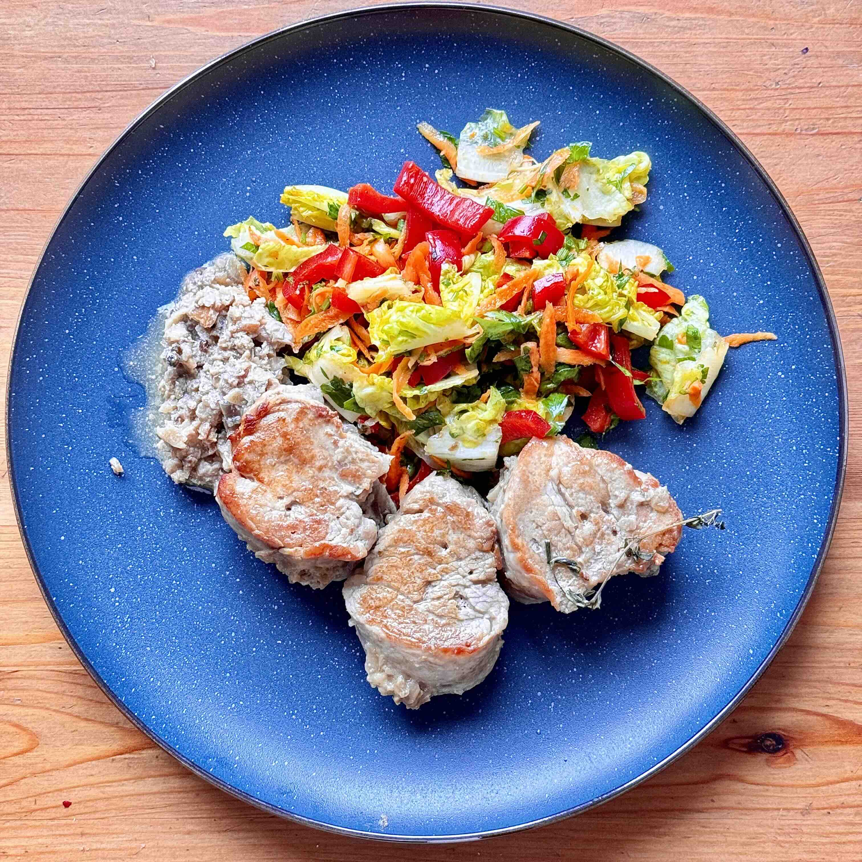 Finished creamy pork tenderloin garnished with salad.