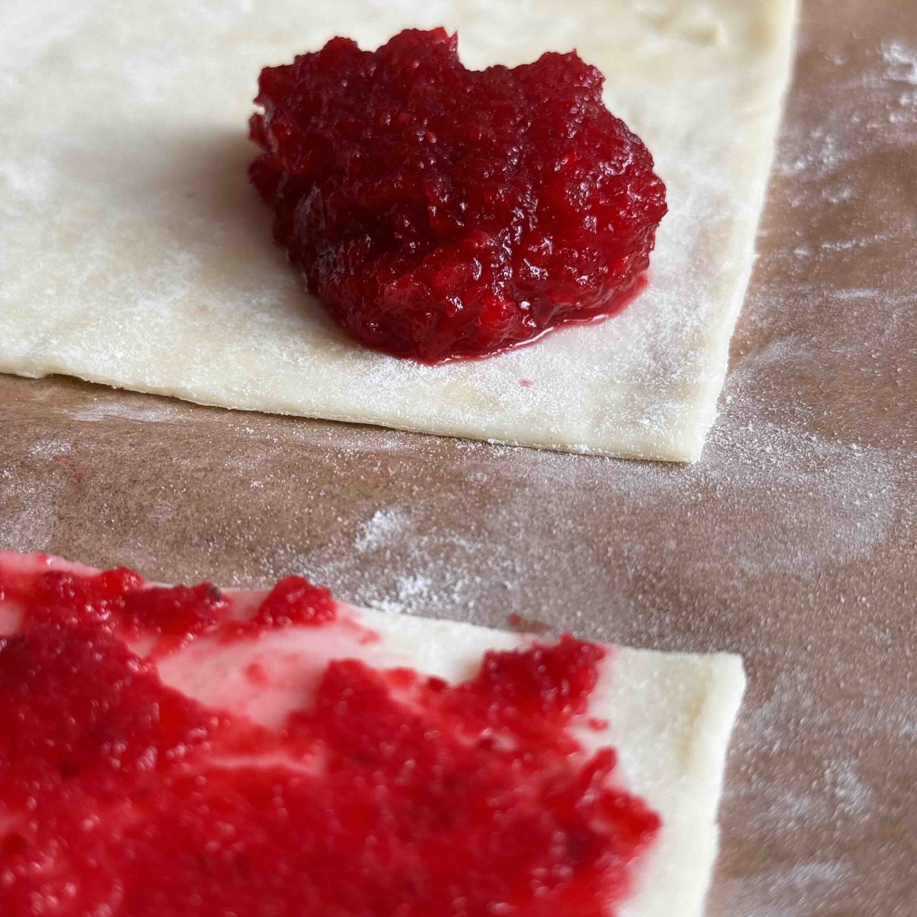 Cranberry jam spread on puff pastry