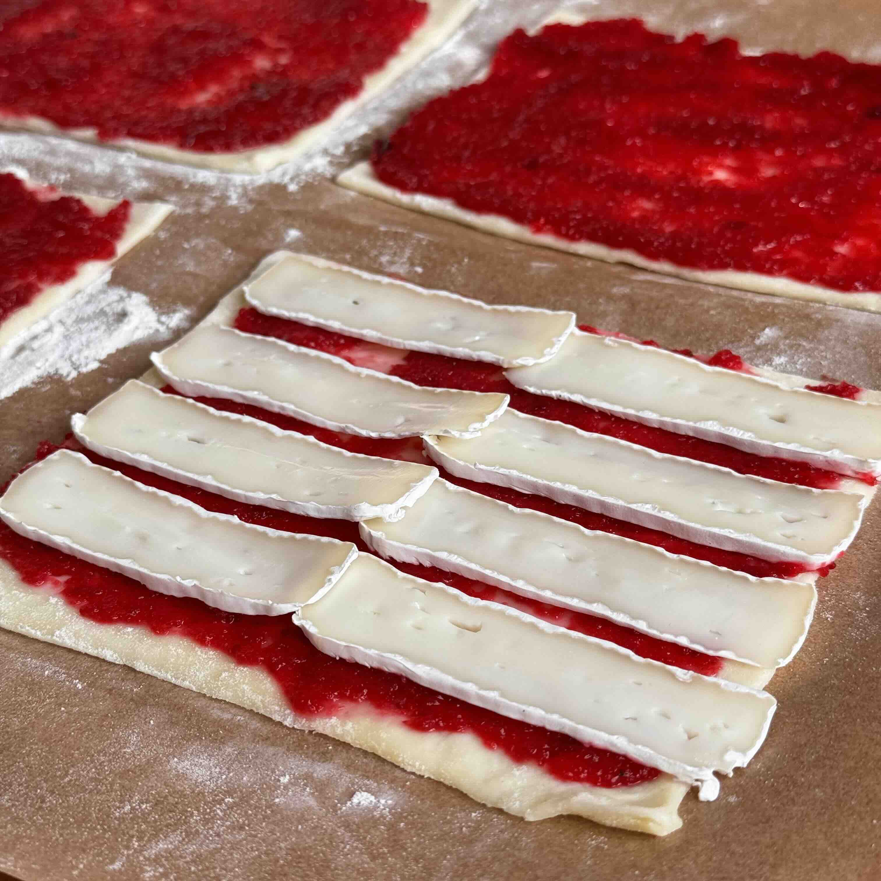 Brie pieces placed over cranberry jam