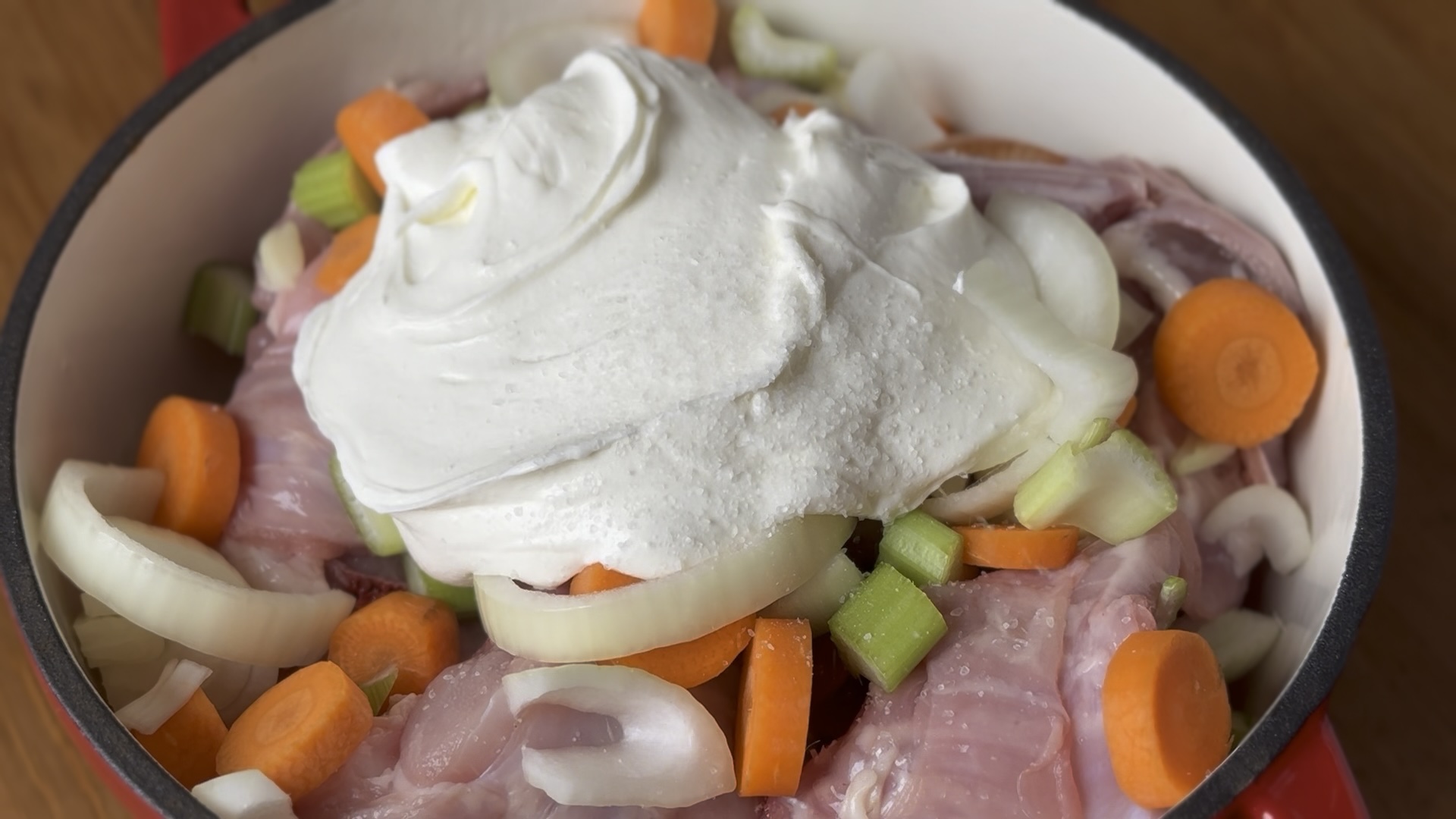 Vegetables in a saucepan with the rabbit and sour cream